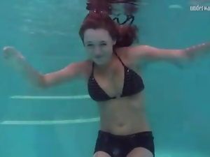 Redhead in cute bikini goes swimming