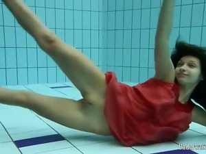 Slender teen goes swimming in her red dress
