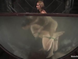 Gorgeous brunette gets toyed by a blonde in water bondage video