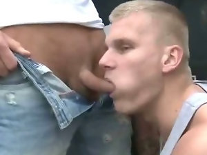 Hot and horny hunk sucking on a cock outdoors