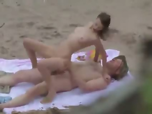 Sexy brunette spied while fucking on the beach