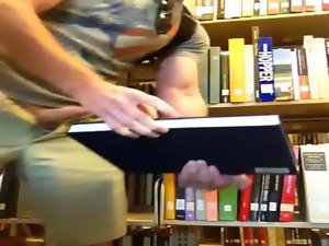 Cumming in a book in the library
