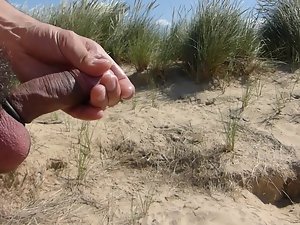 In the dunes at public beach playing with penis and balls