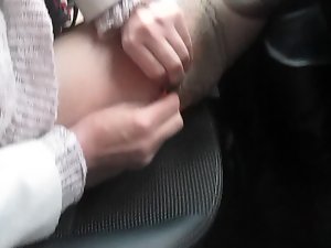 Young lady changing pantyhose and stockings in a car