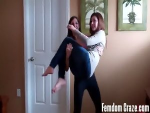 Two femdom mistreses lift carry each other