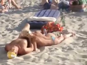 Cock sucking on a public beach