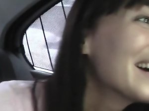 Dark haired is getting cumshot in the mouth while in the back of a car
