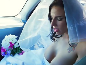 A female gets penetrated in her wedding gown on the bed
